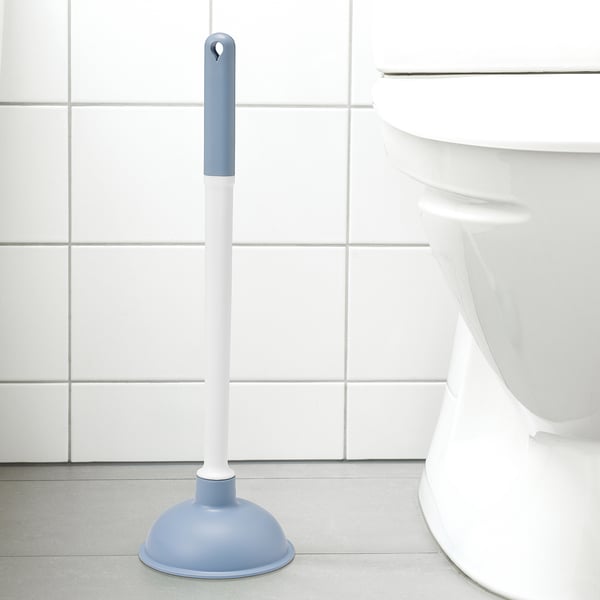 Blue & white plunger beside white toilet, fits in tight spaces.