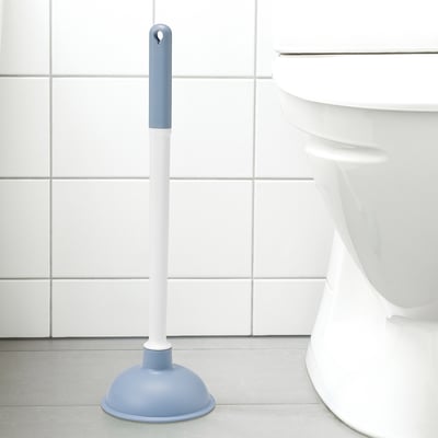 Blue & white plunger beside white toilet, fits in tight spaces.