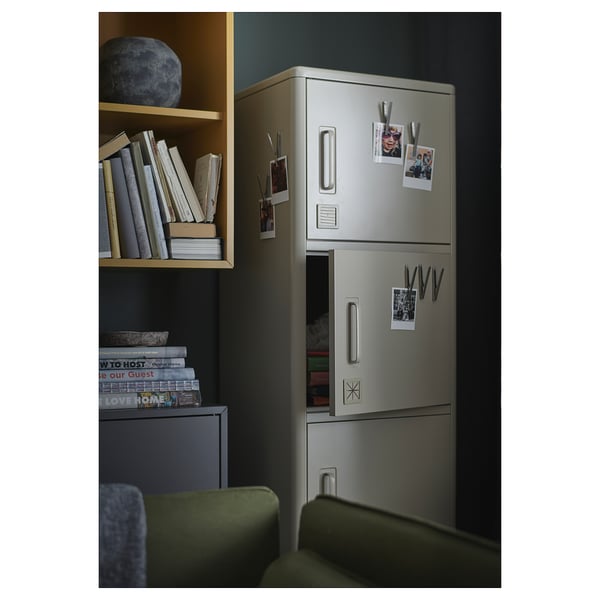 Modern metal locker, IDÅSEN, silver, with magnets for notes, photos. Standing next to shelves with books.