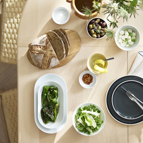 IKEA 365+ bowl: white, porcelain, oval, simple design, moderate size among table items.