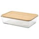 An IKEA 365+ glass container with a bamboo lid. Its clear and rectangular, ideal for storing food in the fridge.