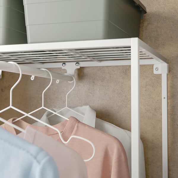 White JOSTEIN closet with clothes, hanging rod, and shelf.