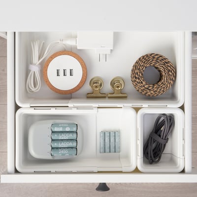 Organised drawer with KACKLA boxes storing cables, batteries, and accessories.