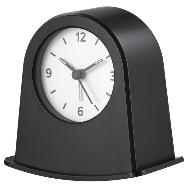 A black KÄRRSÅNGARE clock with a round face and minimalist design.