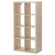 Empty KALLAX light oak storage unit with multiple open cubes.