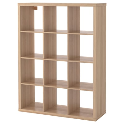 The IKEA KALLAX shelving unit in light oak colour, featuring multiple square compartments for storage.