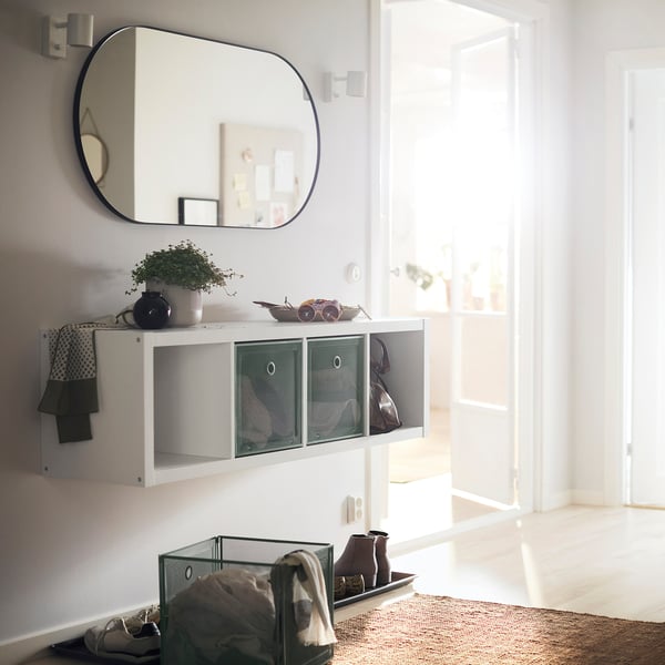 KALLAX shelf with plants, tray, bag, mirror, towel.