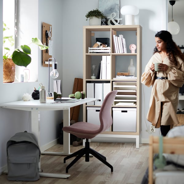 Home office with KALLAX shelves, chair, and accessories.
