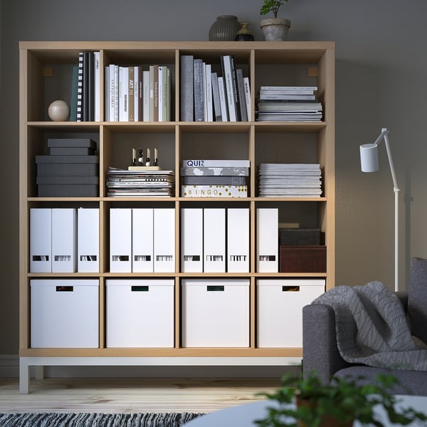 KALLAX bookshelf in beige/white with compartments and decor.
