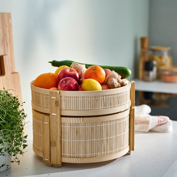 KANELMOTT bamboo fruit basket holds colourful fruits. Natural, round, two-tiered design.