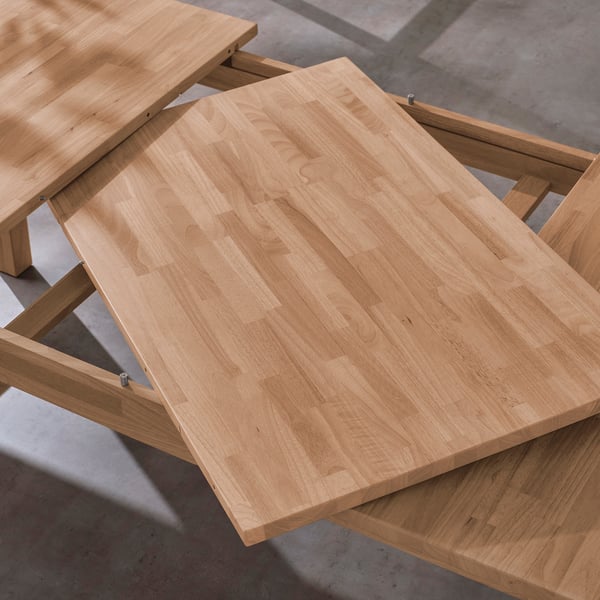 Extensible wooden table with extra leaf stored underneath, seats 6-8. Ideal for hosting, sturdy and stable.