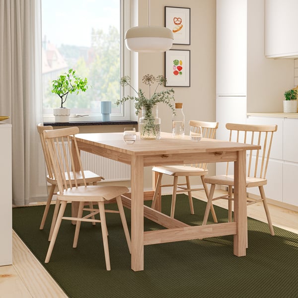 KARSKÄR dining set with extendable table, four chairs, and art near window.