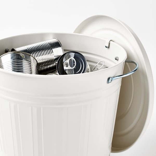 White bin with lid, holding empty metal cans. Hook under lid for hanging.