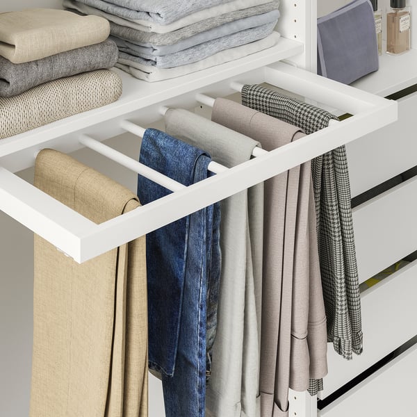 A KOMPLEMENT trouser hanger inside a wardrobe. It holds six pairs of trousers neatly in view and reaches.