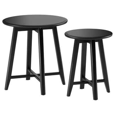 Image two black round nesting tables with sleek legs, modern design.