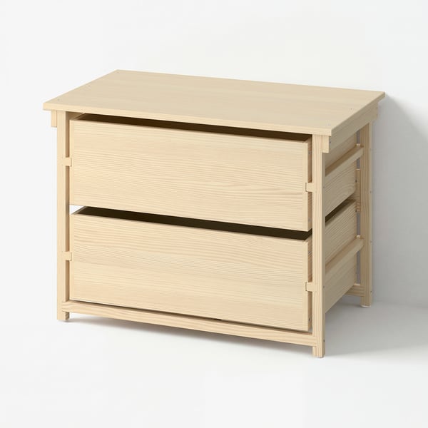A light wooden chest of drawers with two large drawers, in a scandinavian design.