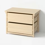 A light wooden chest of drawers with two large drawers, in a scandinavian design.