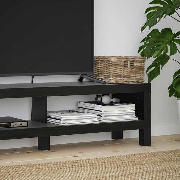 BLACK tv stand with open shelves. Holds magazines and electronics. Basket and plant decorate top.