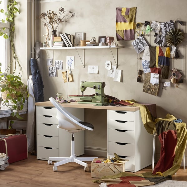 Workspace with LAGKAPTEN desk, sewing machine, decor, and plant.