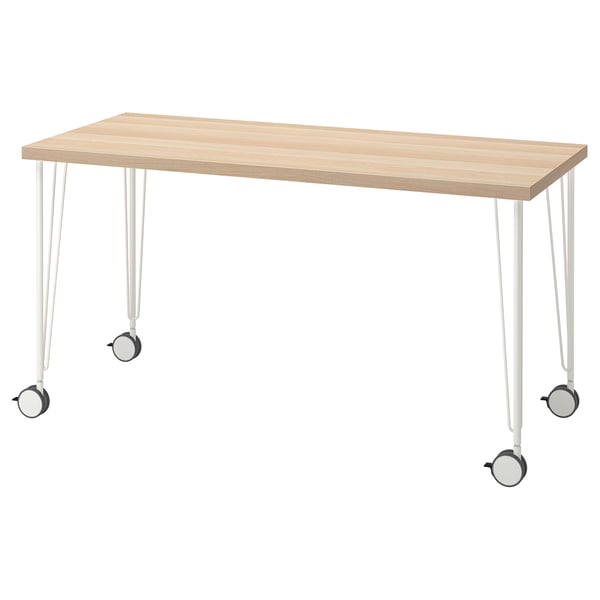 LAGKAPTEN: light wood desk on white legs with castors.