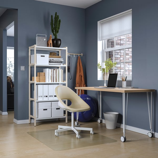 Home office with white LAGKAPTEN desk and chair, bookshelf, laptop, and window.