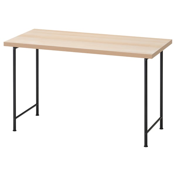 A light-colored wooden desk with black metal legs. It has a rectangular top and is supported by four angled legs.