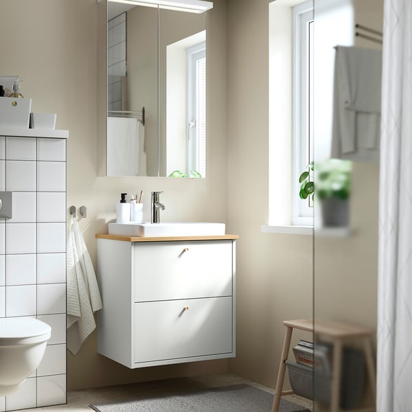 Modern bathroom with mirrored LETTAN cabinet above sink, brightening the space.