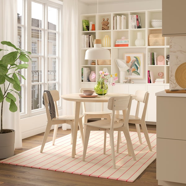Modern dining setup with LISABO table, chairs, and plant.