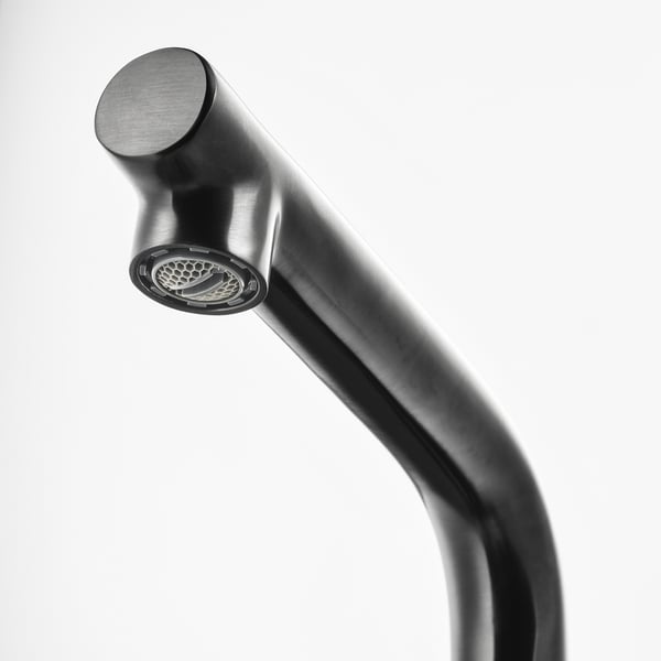 Modern black tap with rounded design, featuring a built-in aerator for water regulation, representing durability and efficiency.