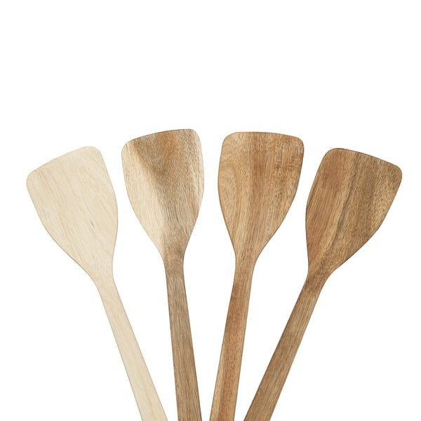 Four wooden spatulas in natural colours, laid side by side, with smooth surfaces and tapering ends, perfect for kitchen use.