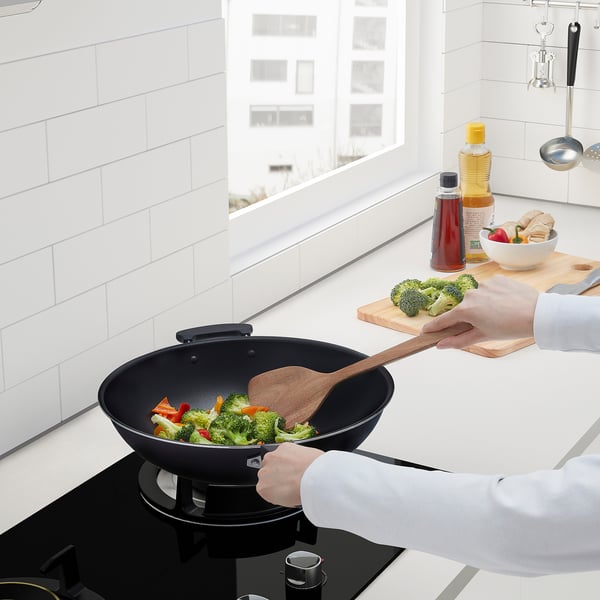 Cooking colourful veggies in wok with broccoli nearby. Or wok cooking colourful veggies near broccoli.