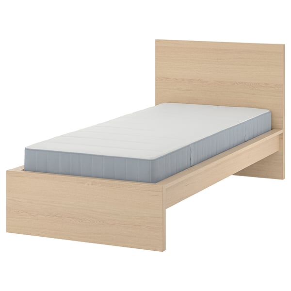 Light wood MALM bed with blue mattress, clean, modern. Headboard against white wall.