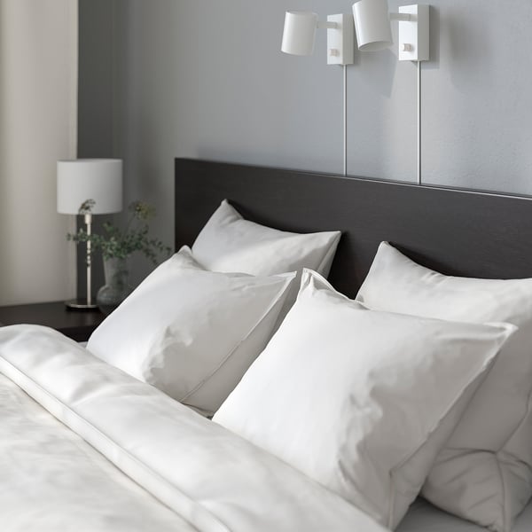 Bedroom with MALM bed, lights, bedside table, lamp, and plant.