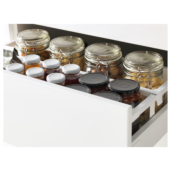 Open kitchen drawer filled with jars of preserved foods and jams, demonstrating its full-extension and soft-close.