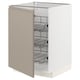 A white cabinet from IKEAs METOD kitchen system with beige doors and wire shelves.