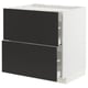 A modern, white METOD kitchen cabinet with black nickebo drawers. It full-extension drawers with a sleek, minimalist design.
