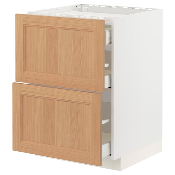 A METOD kitchen cabinet with vedhamn oak fronts. It has two drawers and a white frame. The cabinet is rectangular with a natural wooden finish.