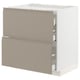 A modern, minimalist kitchen unit named METOD in beige with grey handles, featuring smooth-running drawers.