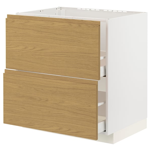 A white METOD kitchen cabinet with oak-colored drawers, simple design, and built-in handles.