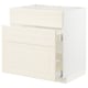 An off-white METOD kitchen cabinet with bevelled edges, featuring a structured design and smooth-running drawers.