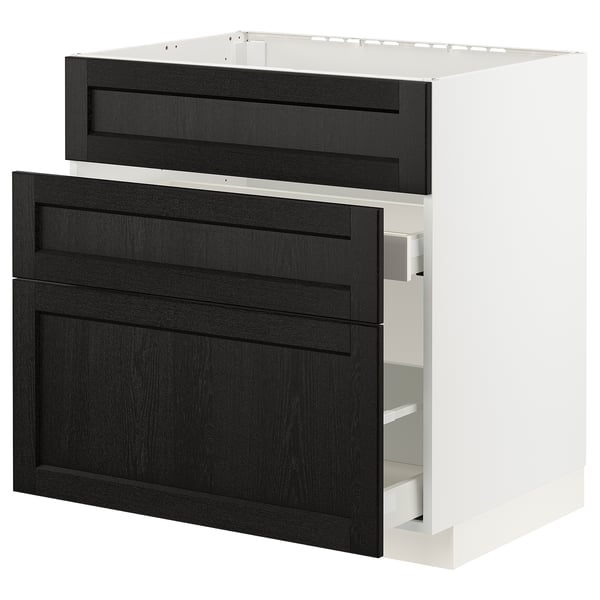 A black stained wooden drawer unit from the METOD kitchen system, featuring clean lines and bevelled edges, set against a white cabinet frame.