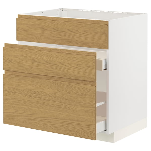 A white METOD kitchen cabinet with oak effect drawers and minimalist handles, combining warmth and modern design.