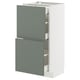 A modern kitchen cabinet from the METOD system with grey-green nickebo fronts. It has one drawer and one door, both partially open.