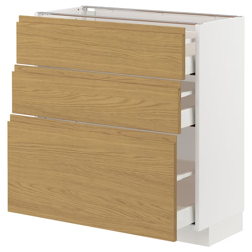 A white METOD kitchen cabinet with three wooden drawers in a light oak finish.