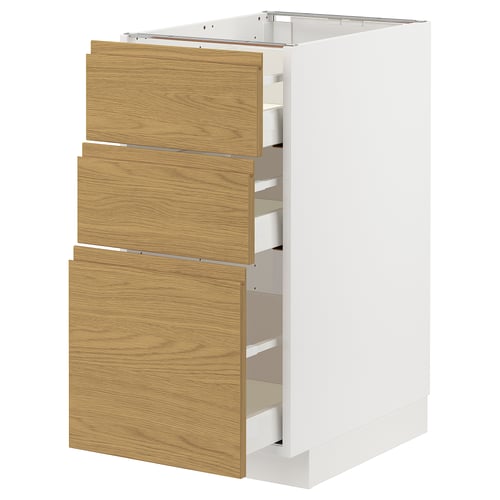 White METOD kitchen cabinet with three wooden drawers in a warm oak finish. Vertical, rectangular, and modern.
