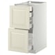 White METOD kitchen cabinet with off-white bodbyn drawers, smooth and modern, featuring bevelled edge pull-out drawers.