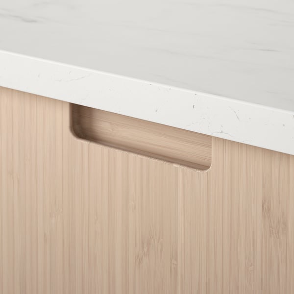 Modern kitchen drawer with smooth bamboo finish and sturdy white countertop, showcasing sleek design.