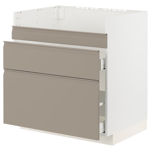 Modern kitchen cabinet with beige-beige drawer fronts and minimalist handles, featuring integrated handles and chamfered edges.