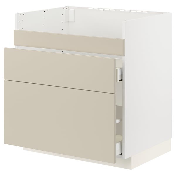 Modern light beige kitchen cabinet with smooth surfaces and soft-closing drawers.