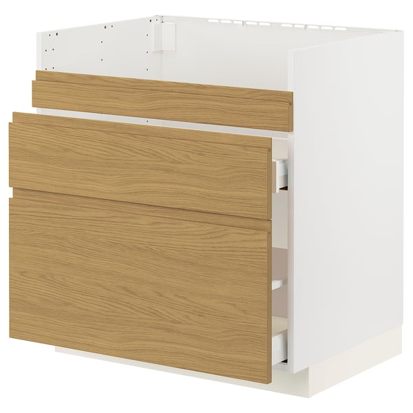 An ikea METOD kitchen cabinet in white and oak. It has integrated handles and is part of the voxtorp series.